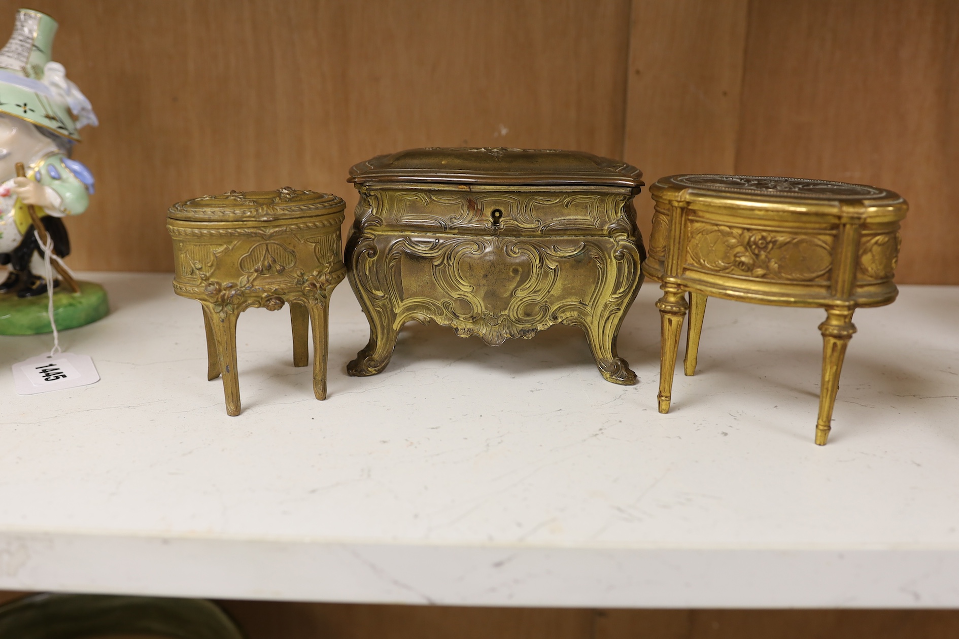 Three French gilt metal miniature novelty jewellery caskets modelled as various items of furniture, largest 14cm wide. Condition - fair to good